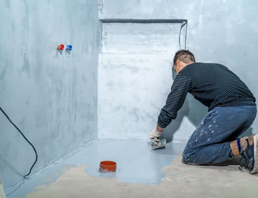 Floor Waterproofing - A Man Waterproofing a Basement Floor