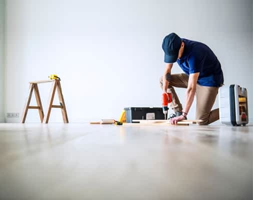 Basement Finishing and Remodeling Contractor New York - A Man Working on a Floor