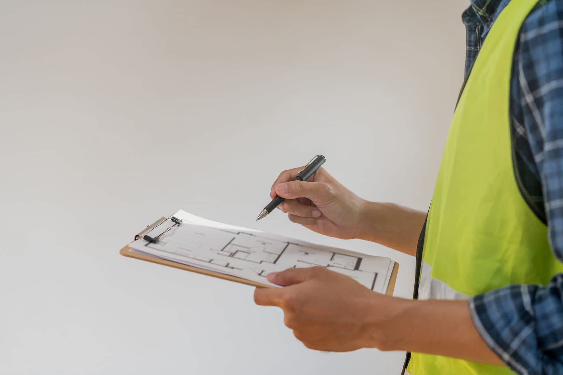 Crawl Space Support Contractor New York - A Man with a Yellow Vest on Holding a Clipboard and Pen